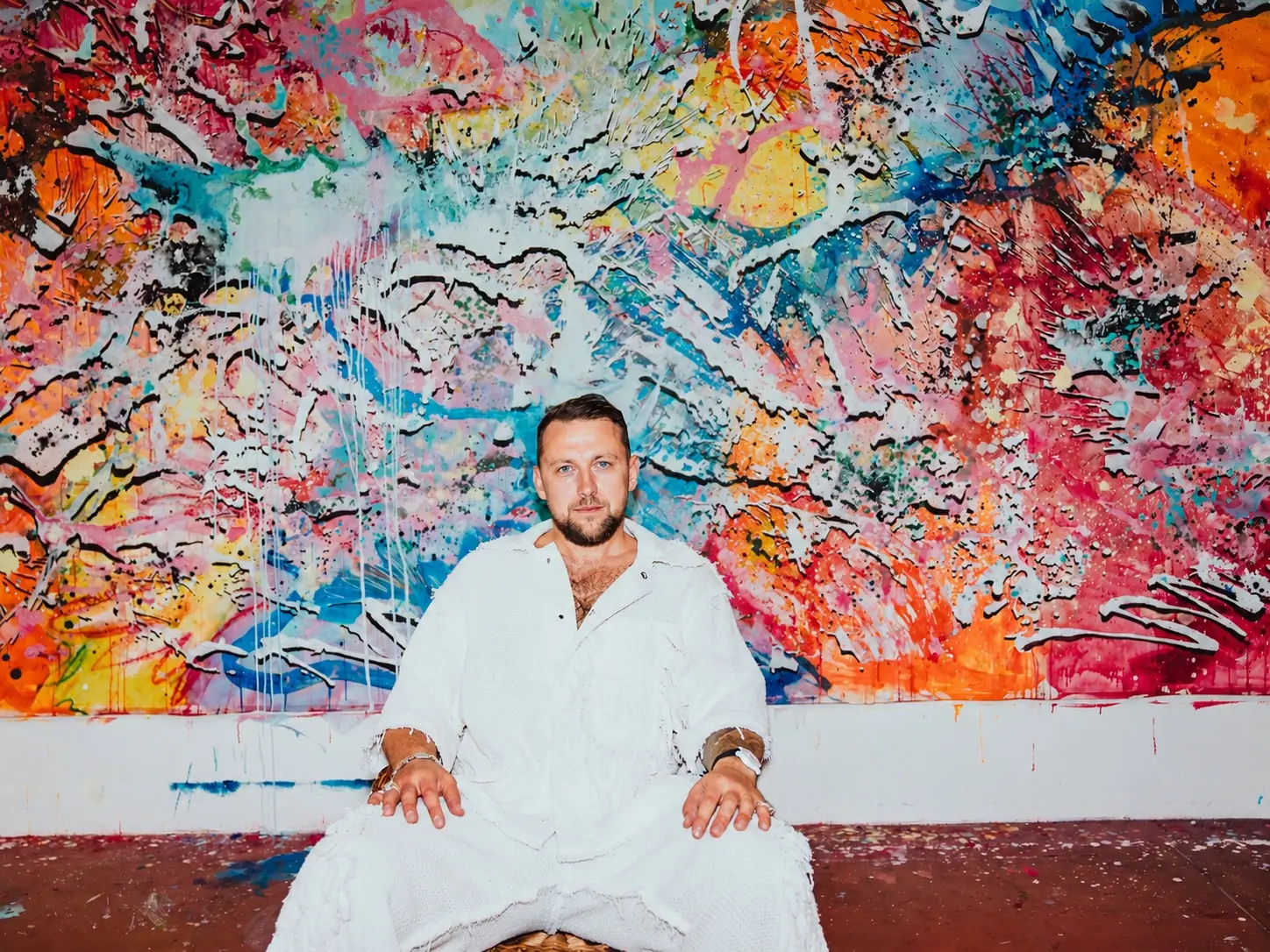 Ivan Gette in front of one of his paintings